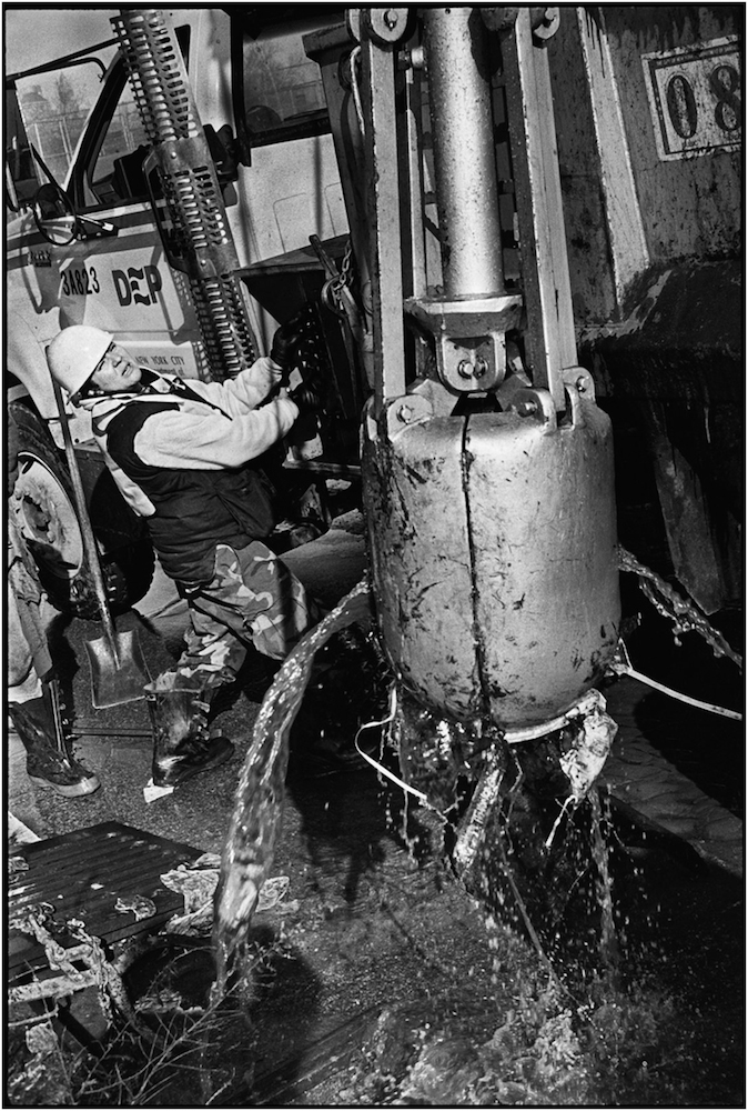   Marga Rodriguez, a Department of Environmental Protection Laborer, operates a sewer basin cleaning machine, after a devastating 30-inch water main break in Carroll Gardens, Brooklyn. 1994.  