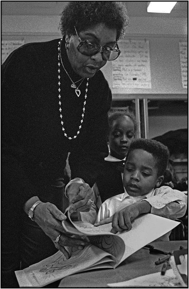   Francis Bartlett, a NYC Board of Education Family Worker, helps a student in an after-school “latch key program,” P.S. 176, Queens. &nbsp;1991.  
