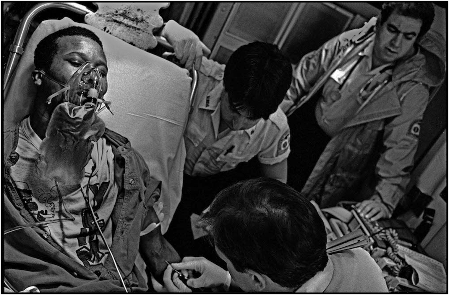   EMS paramedics and technicians, Howard Spielman, Michael Ralmer, and Myra Torres,&nbsp;treat a crack overdose patient. &nbsp;1991.  