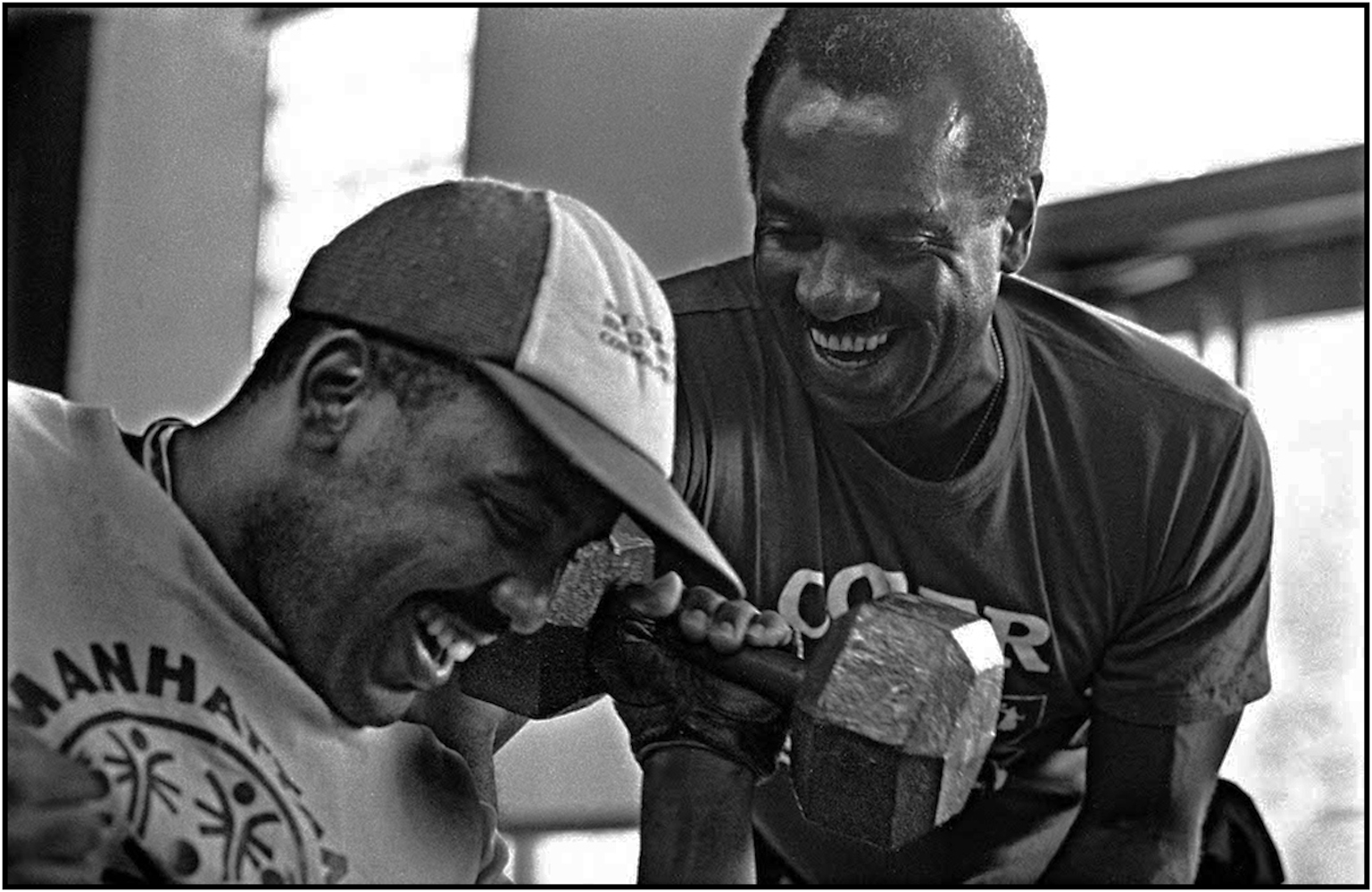 Special Olympics certified instructor and recreation worker, inspires disabled patient Juan Pimintel in wheelchair to lift weights at Coler Memorial Hospital on Roosevelt Island. 1992.