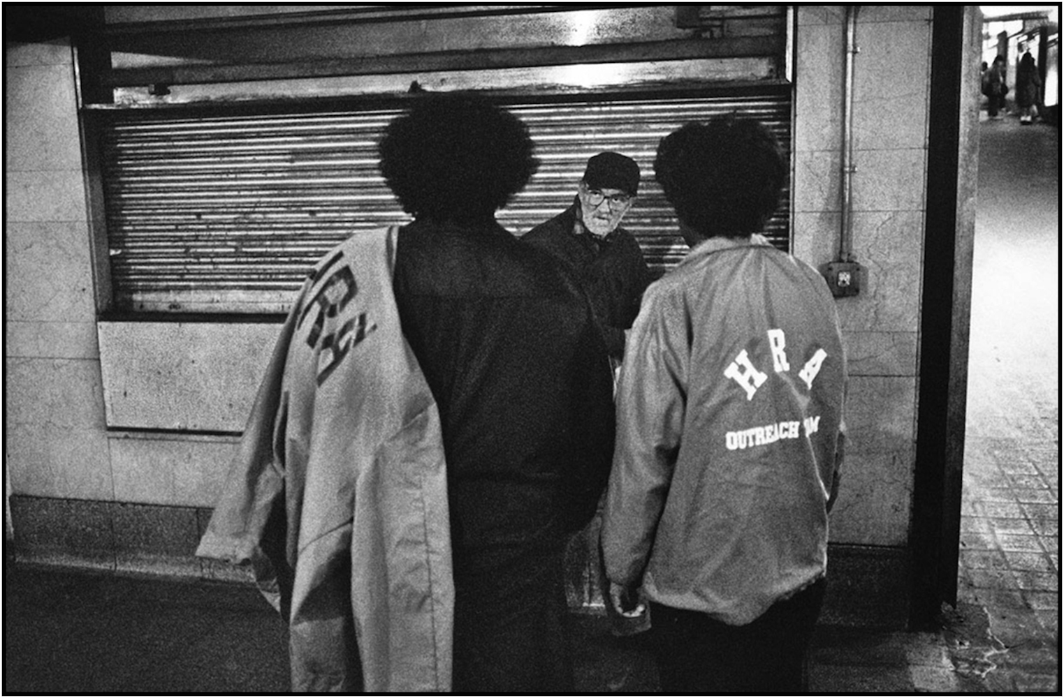  Human Resources Administration workers reach out to homeless man at Grand Central Terminal, Manhattan.&nbsp;1989.  