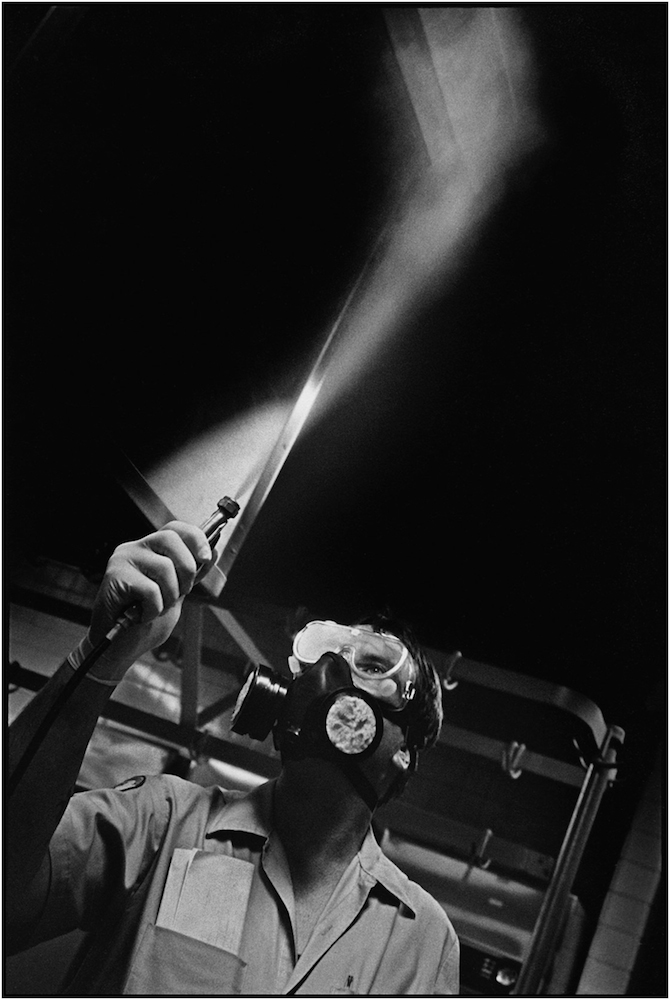   Pest control technician Malcolm Adams fogs an elementary school kitchen in Brooklyn. 1993.  