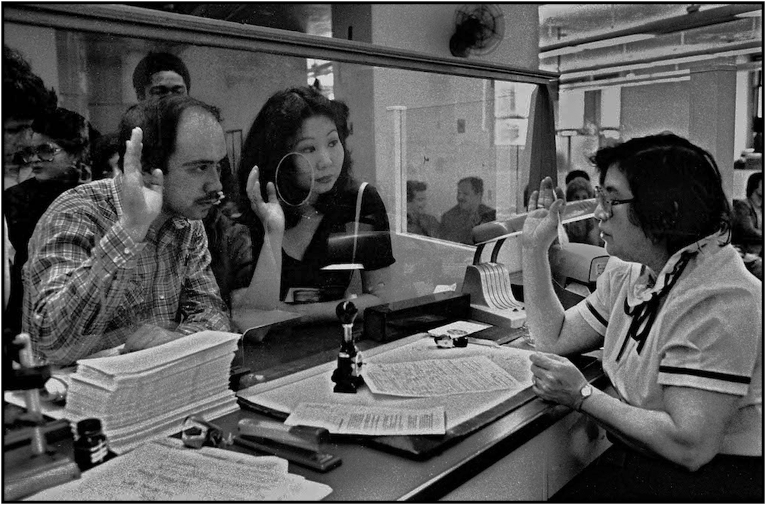 Union member accepts sworn statement from a couple at Marriage License Bureau in Municipal Building, Manhattan. 1981.