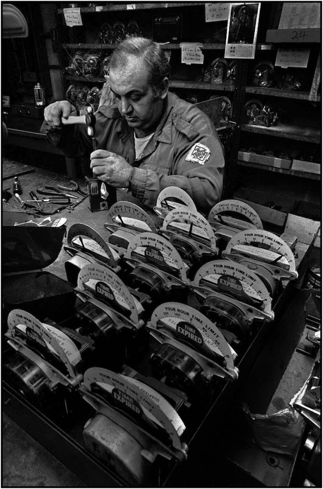  Worker repaires parking meters, Maspeth Queens shop. 