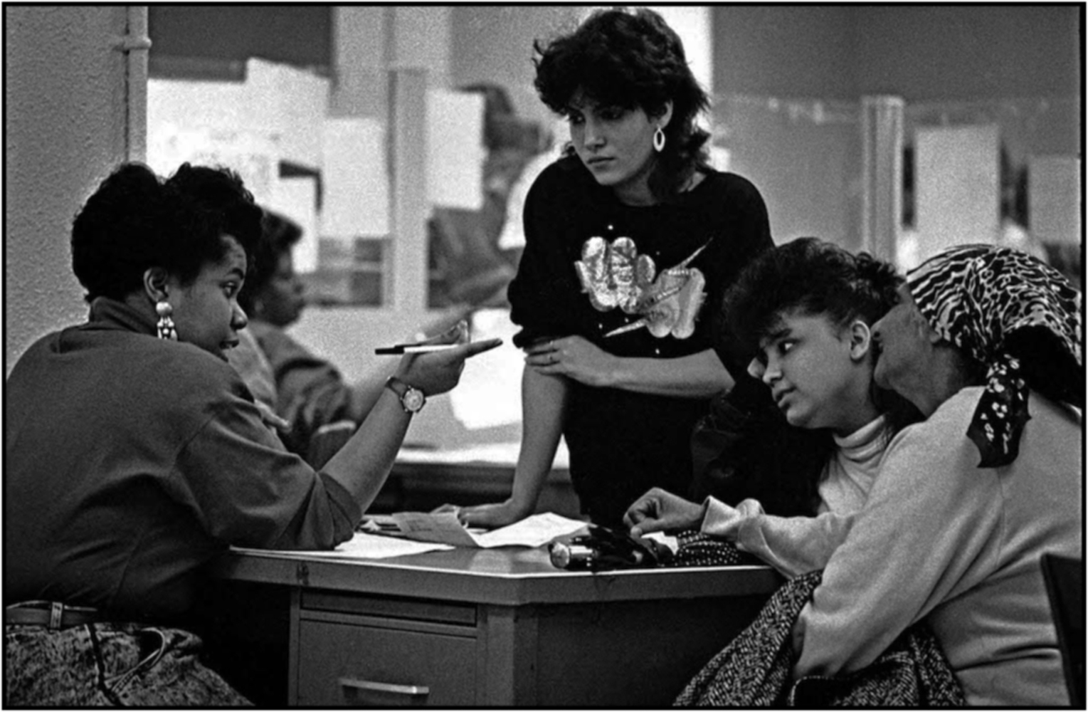   Eligibility specialist Kenyatta Jones (left) works with family at a Queens income maintenance center. 1988.  