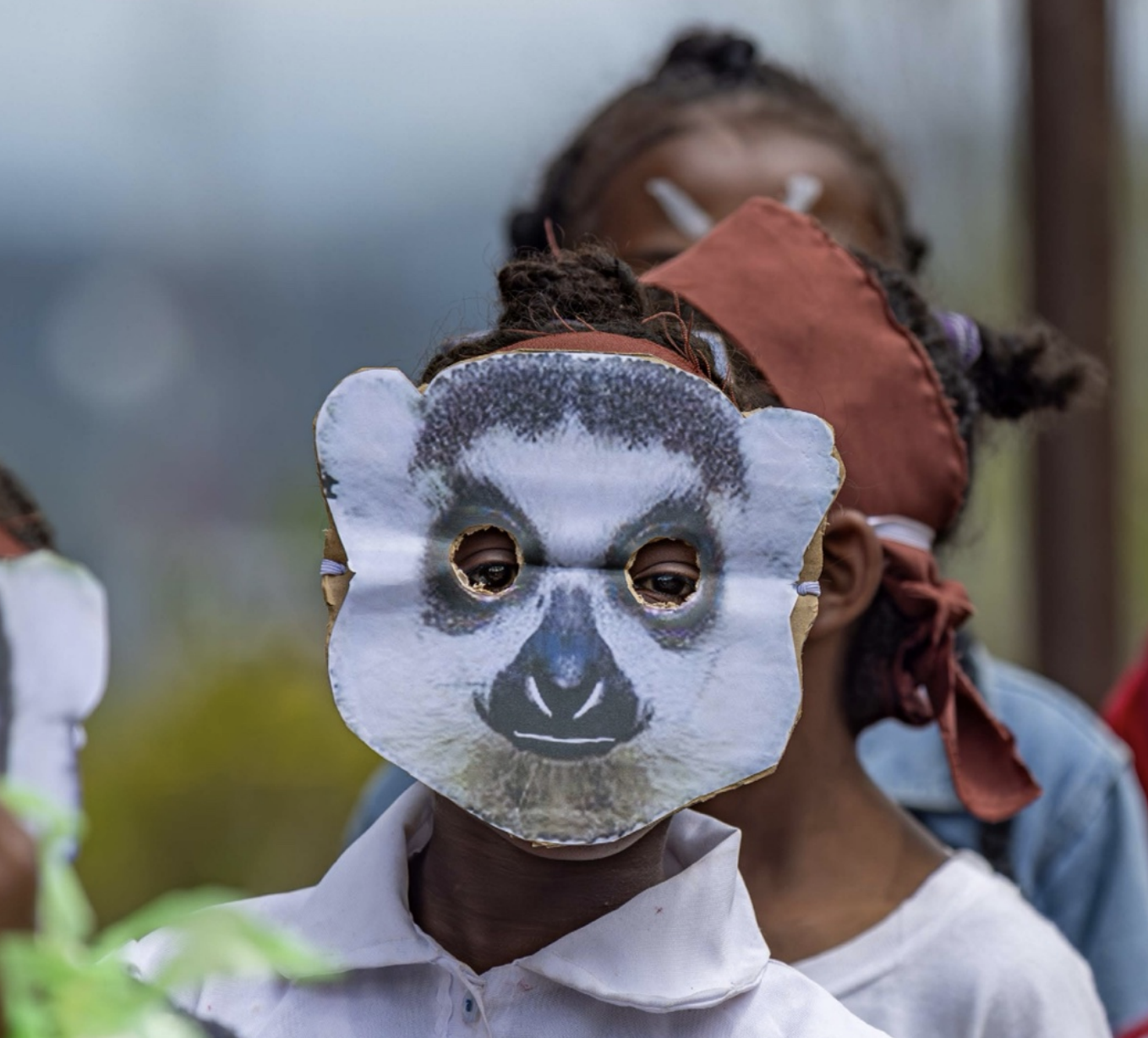 child in lemur mask