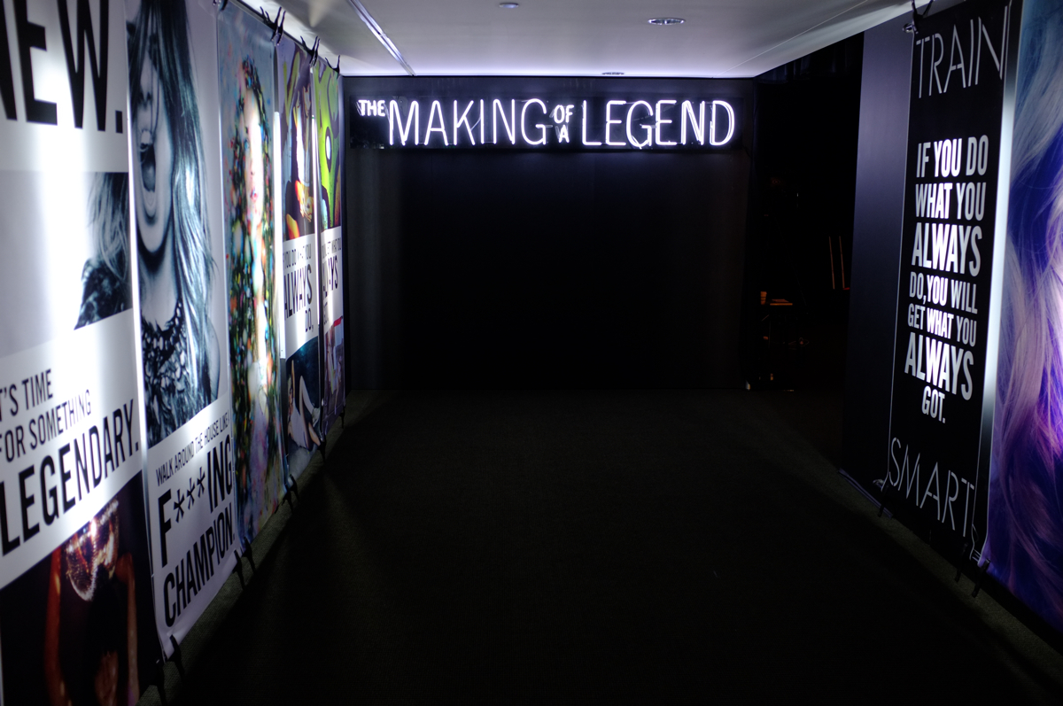 Entrance way to a large internal presentation. Lighting design, graphics and neon literally set the stage for what is beyond. 