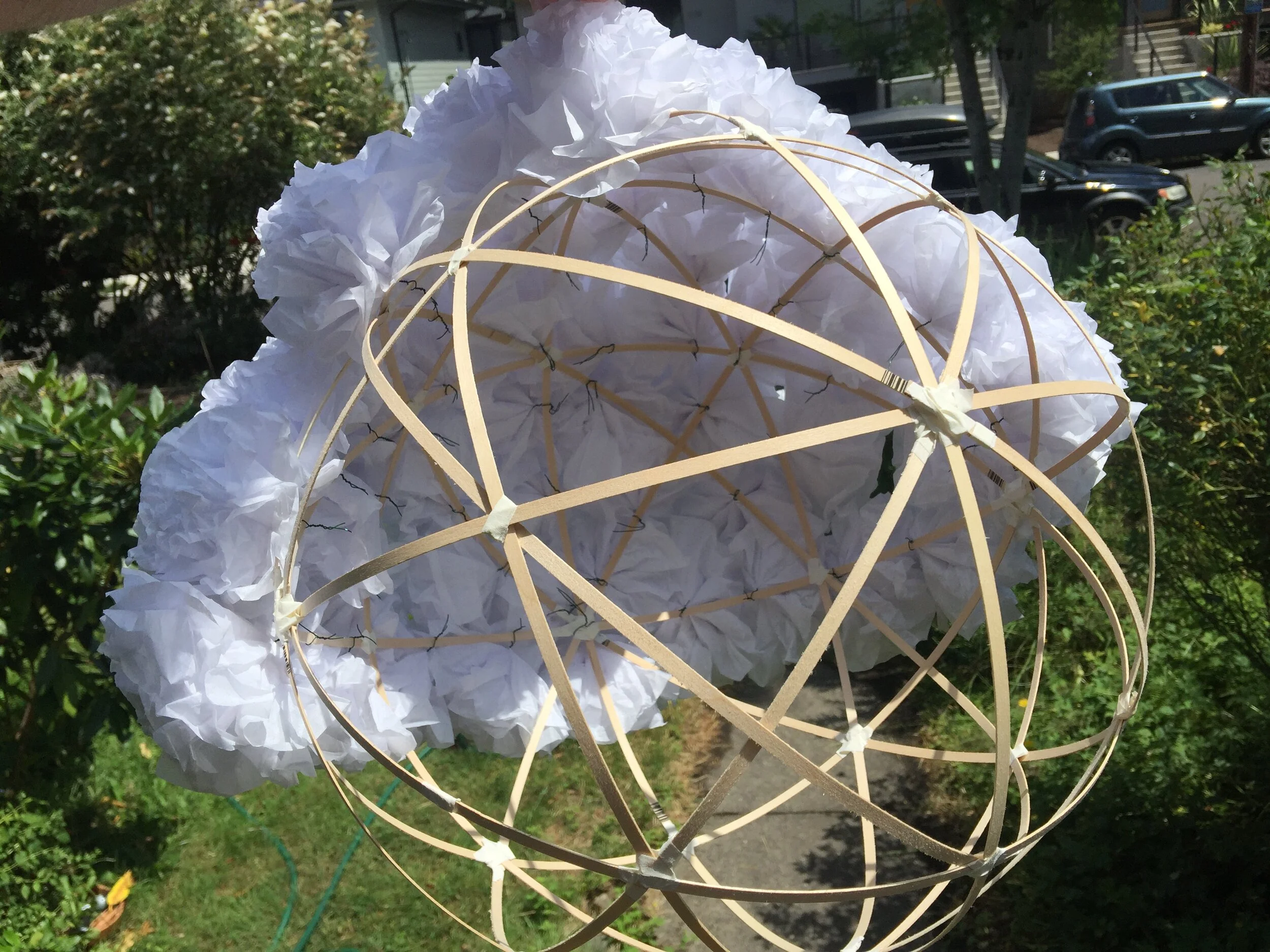  Balsa framing complete, first quadrant of paper flowers attached. Each globe required hundreds of pieces of paper to be crafted into flowers and wired onto the frame. This was a painstaking and zen like process. 