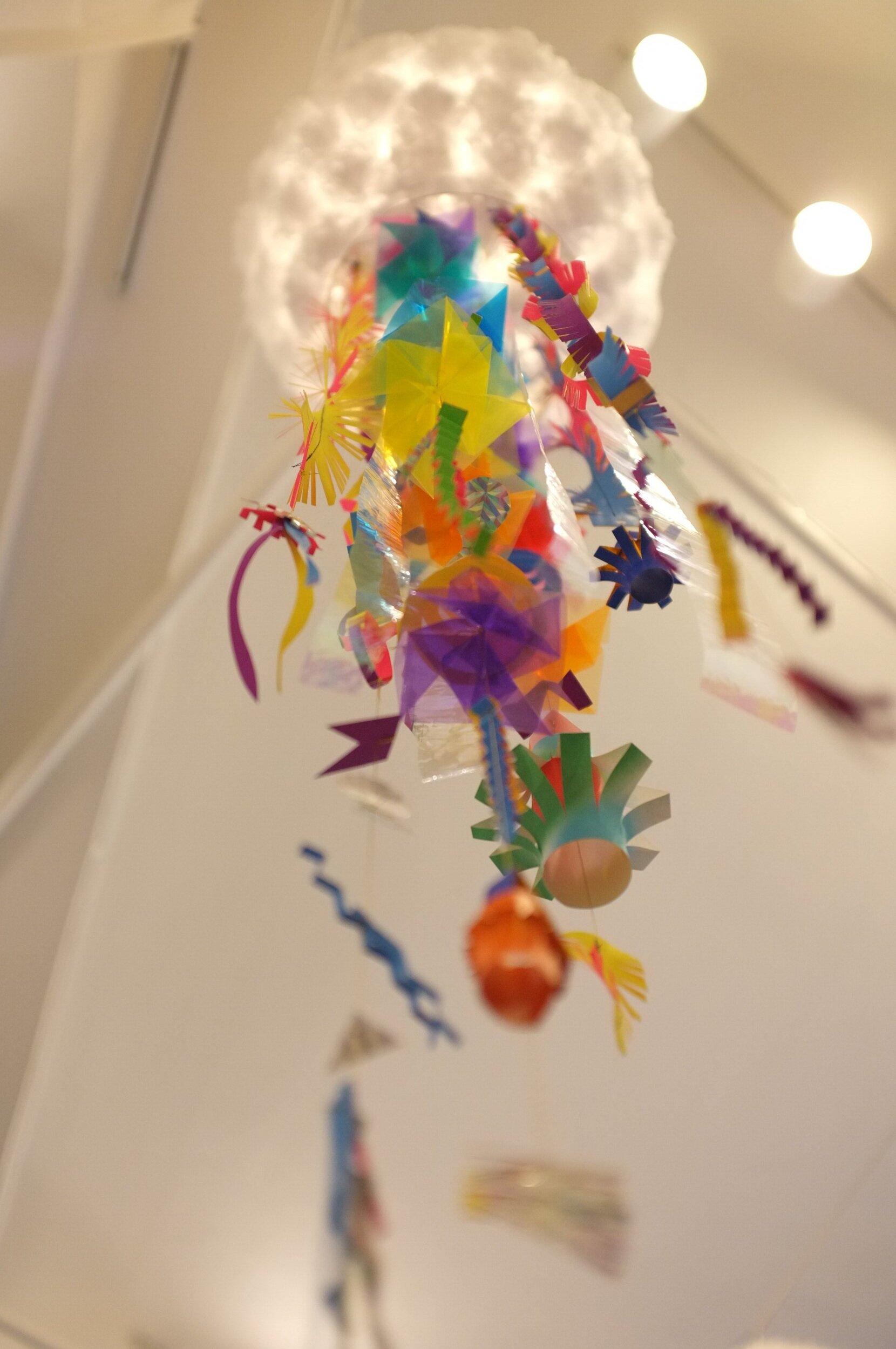 Each lantern was wired with an LED light and adorned with dozens of hand cut, folded, and sewn “doodads” along with transparent, iridescent streamers and origami lanterns and flowers.