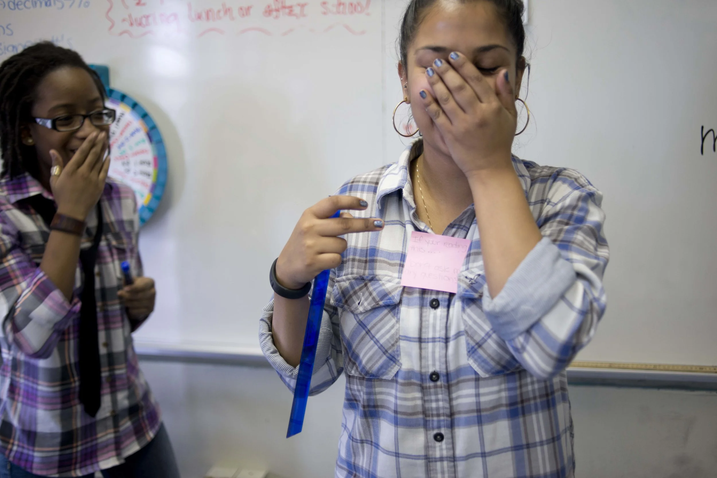 Sari Price, left, a ninth grader, and Ms. Bujan joke during lunch. Many students skip lunch to sit and talk with Ms. Bujan. She says it can be difficult to act as an authority figure because she is so close in age to her students. 