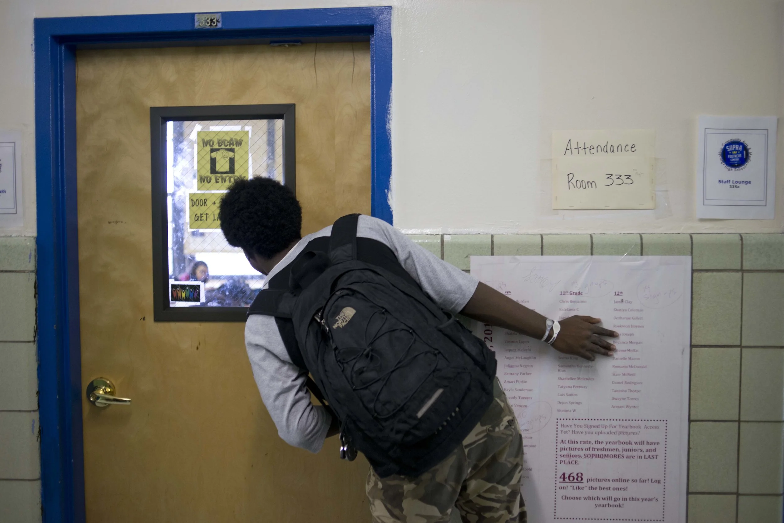Mr. Benjamin peers into Ms. Bujan's classroom after being ejected for being disruptive. Much of Ms. Bujan's day is spent managing students' behavior. "It's not my job," she said. "I'm here to teach."