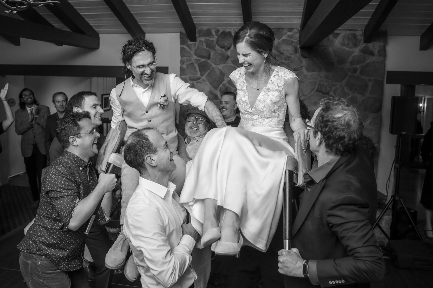 Bride and groom at Mountain Terrace celebrate with their families by doing the hora