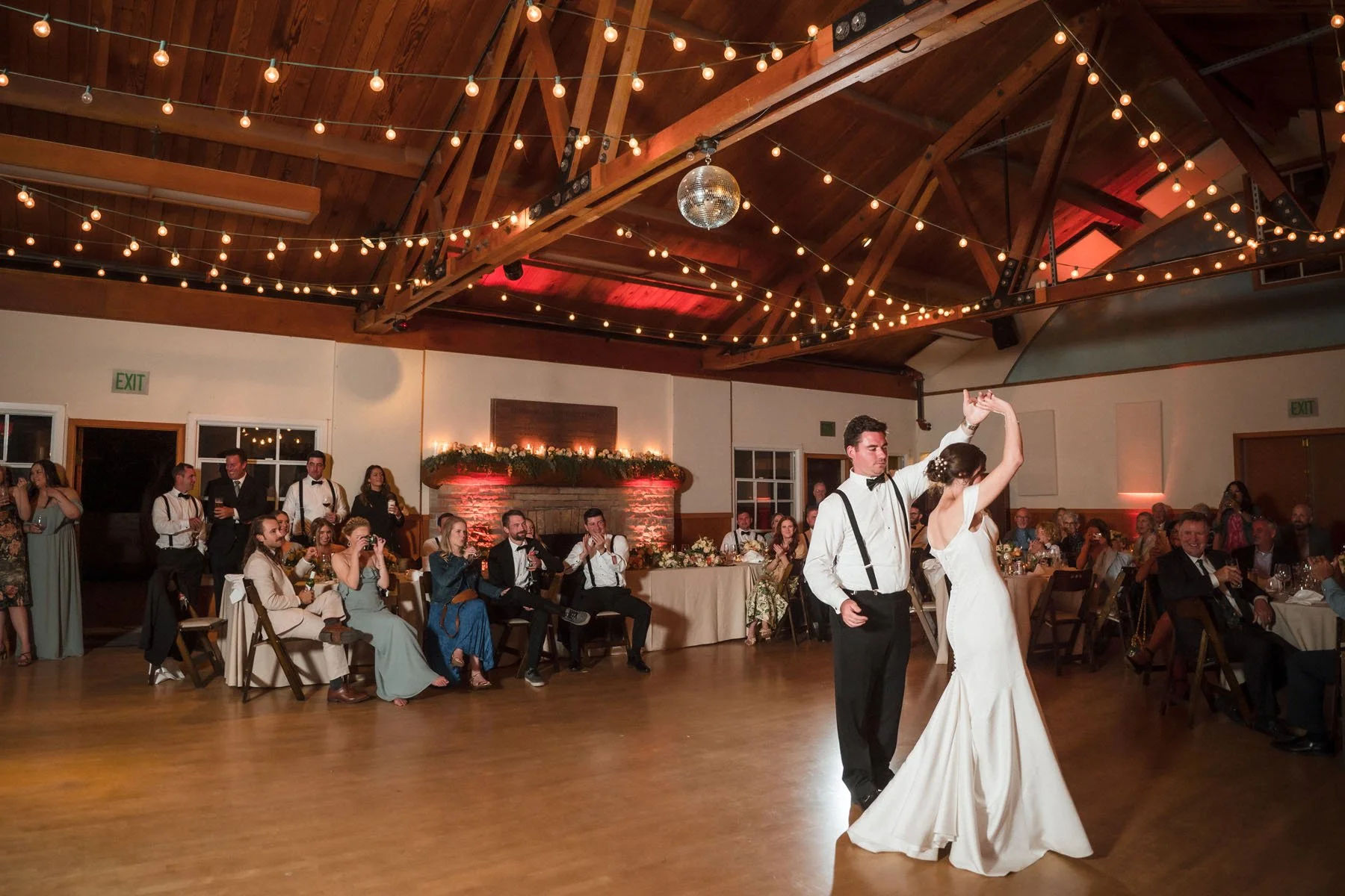 Groom spins his bride during their first dance at their Stinson Beach Community Center wedding.