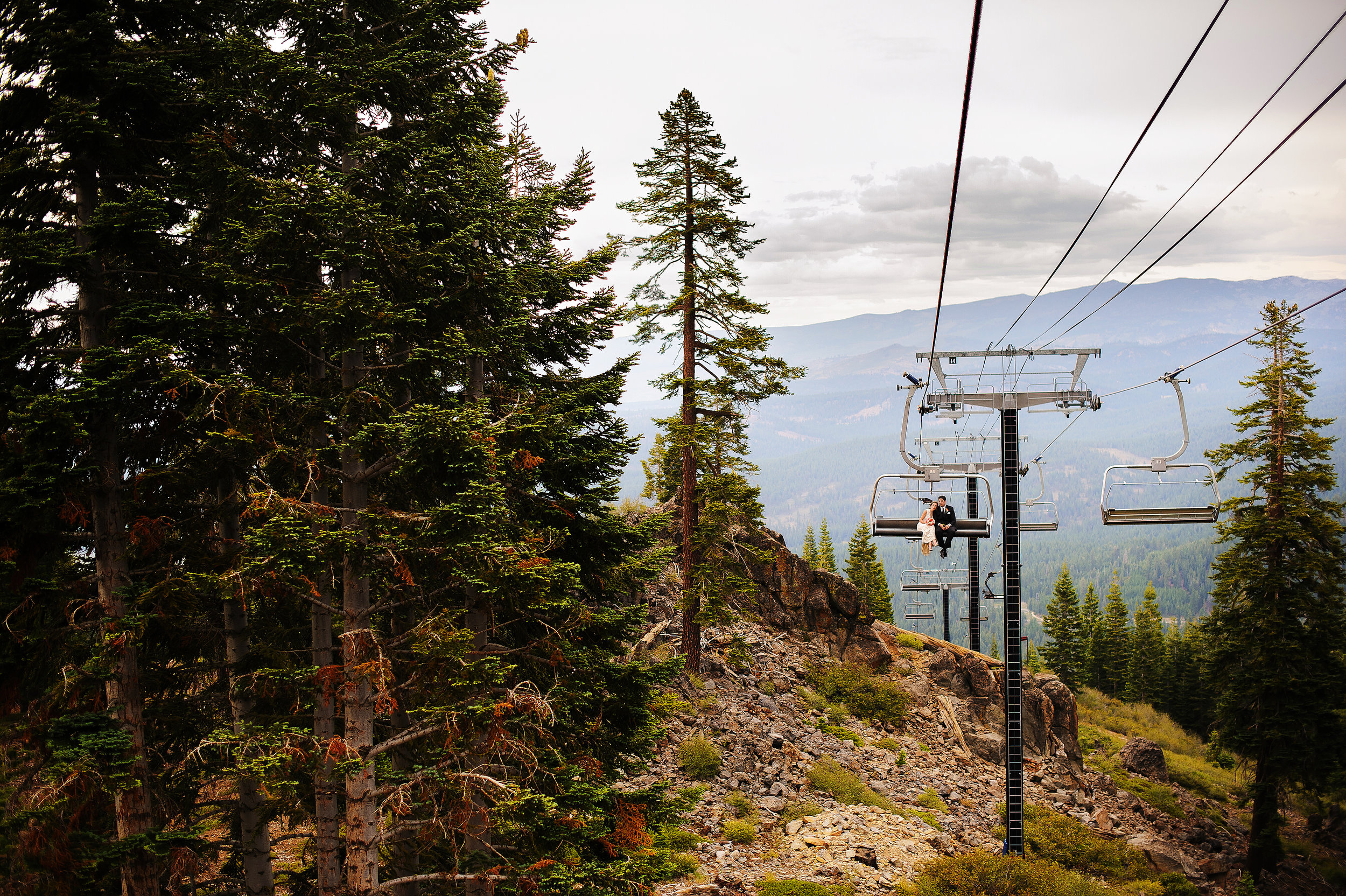  Bride and groom on ski lift at Zephyr Lodge at Northstar California Resort in Truckee California. 