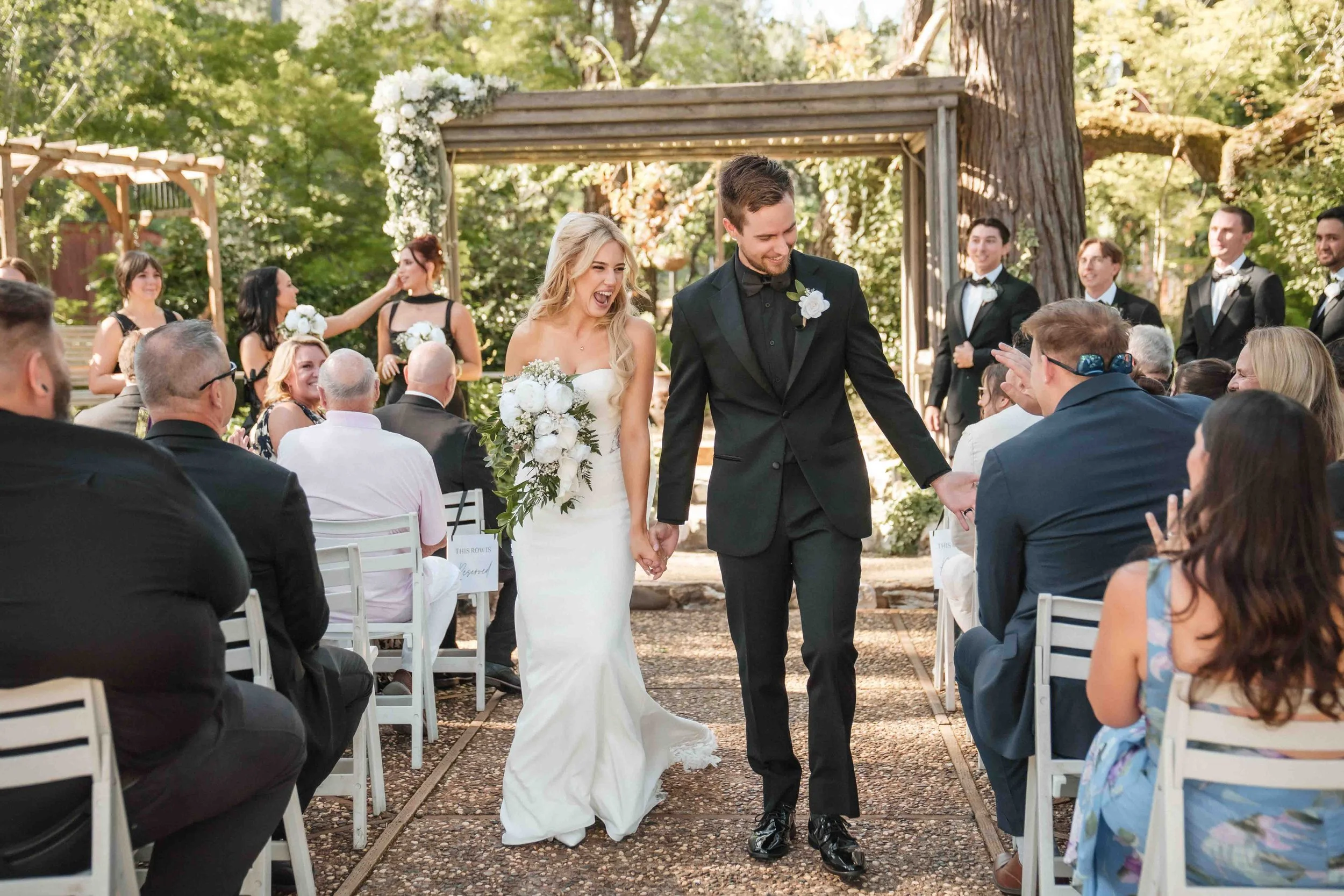 A bride and groom walking down the aisle at their Monte Verde Inn wedding ceremony, photographed by Katherine Nicole Photography.