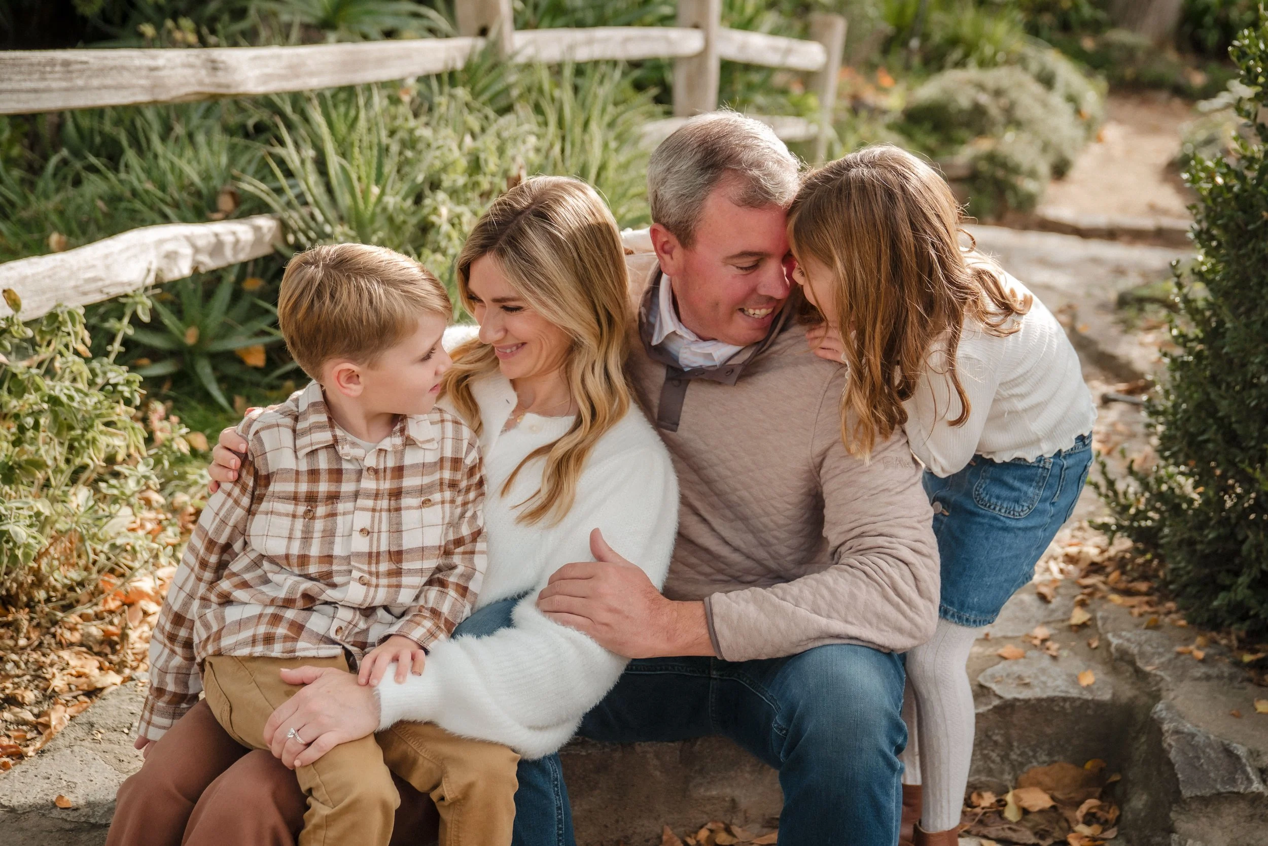 A family of four, enjoying each other's company during photos with Sacramento family photographer, Katherine Nicole Photography.