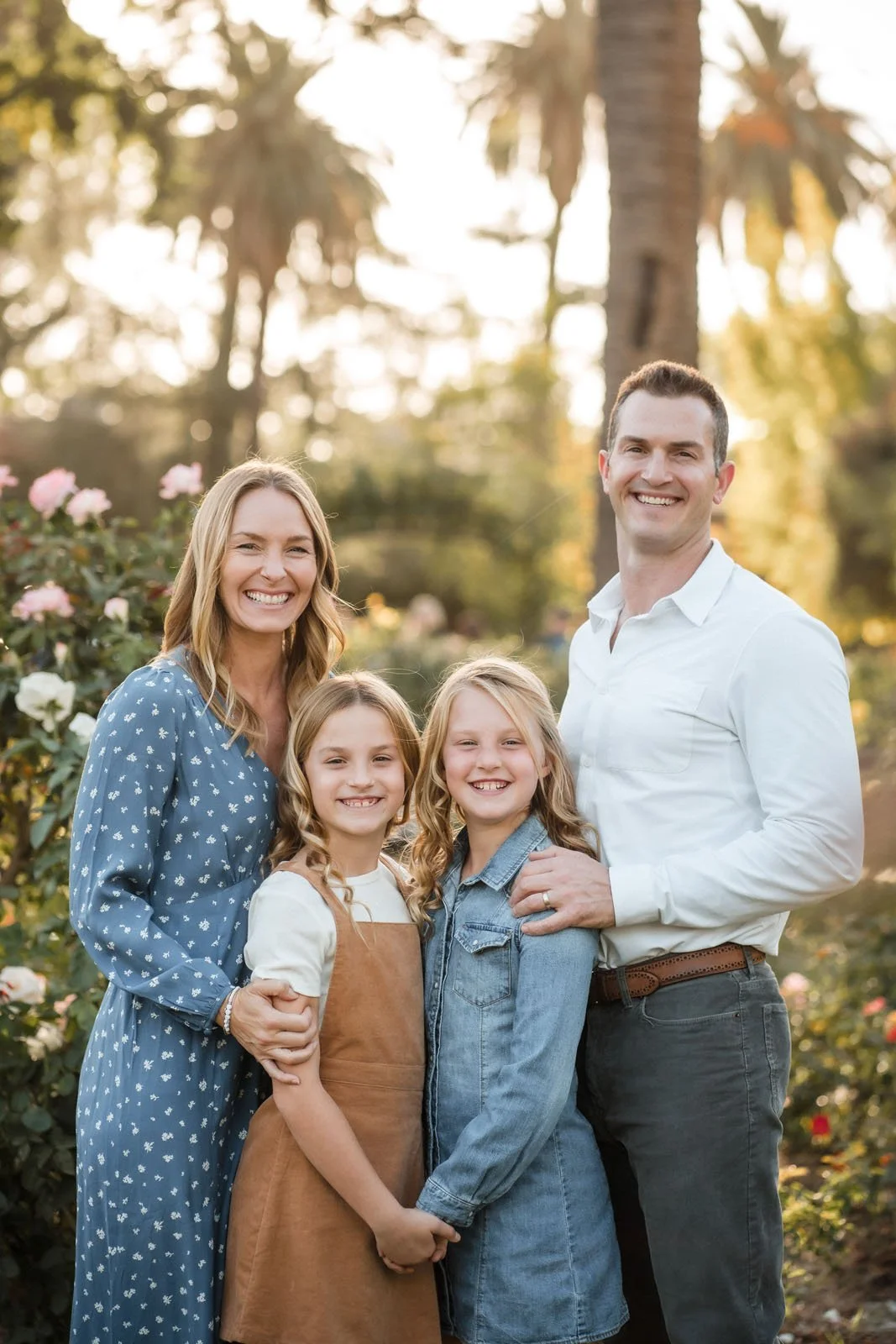 Family portrait taken in McKinley Park rose garden of a Mom and Dad with their two daughters by Katherine Nicole Photography