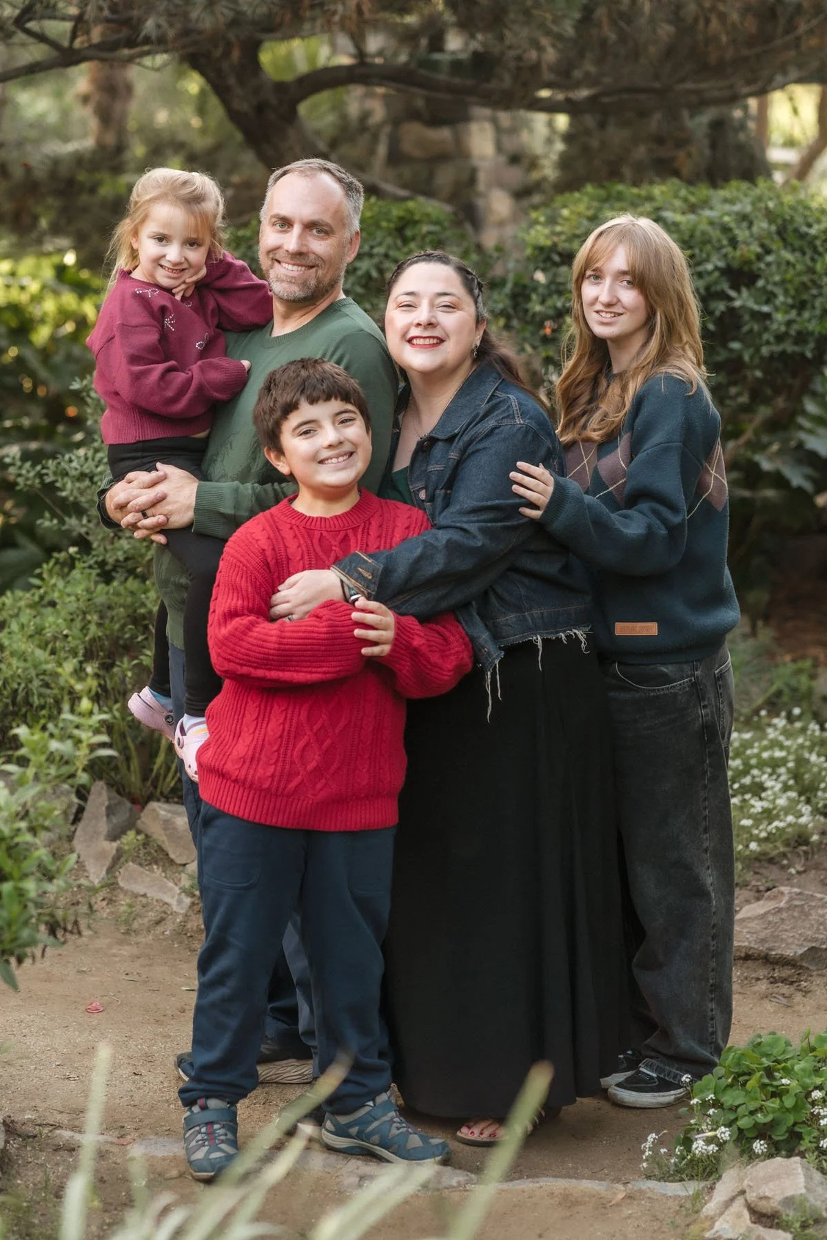 Family of five standing outdoors a the WPA rock garden during their family photos with Katherine Nicole Photography.