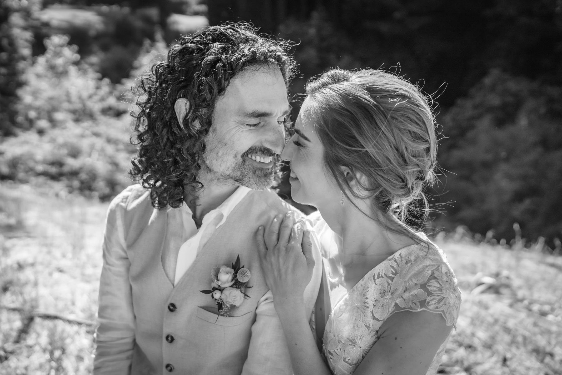 Bride and groom nuzzle each other during a quiet moment at their wedding in Woodside at Mountain Terrace.