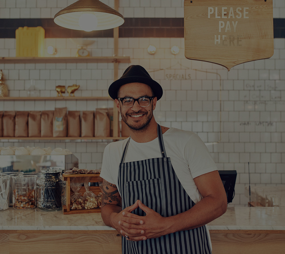 Copy of Copy of Coffee shop worker smiling to camera