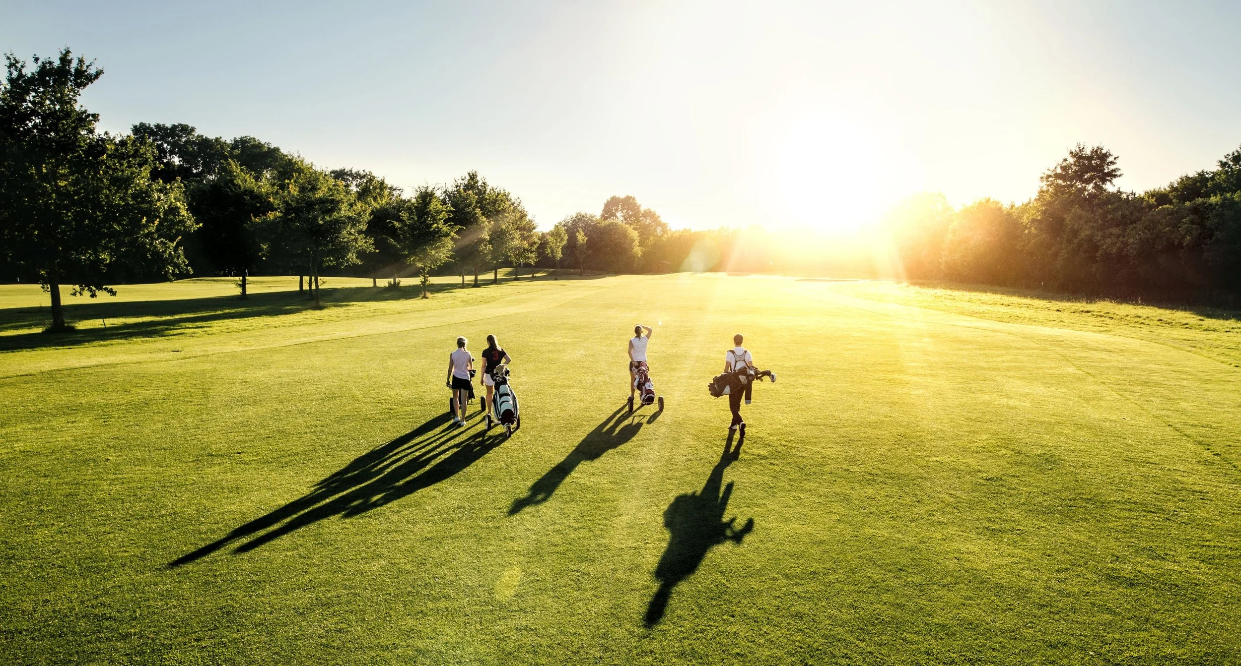 Golfers on a Hunter Valley course at sunset
