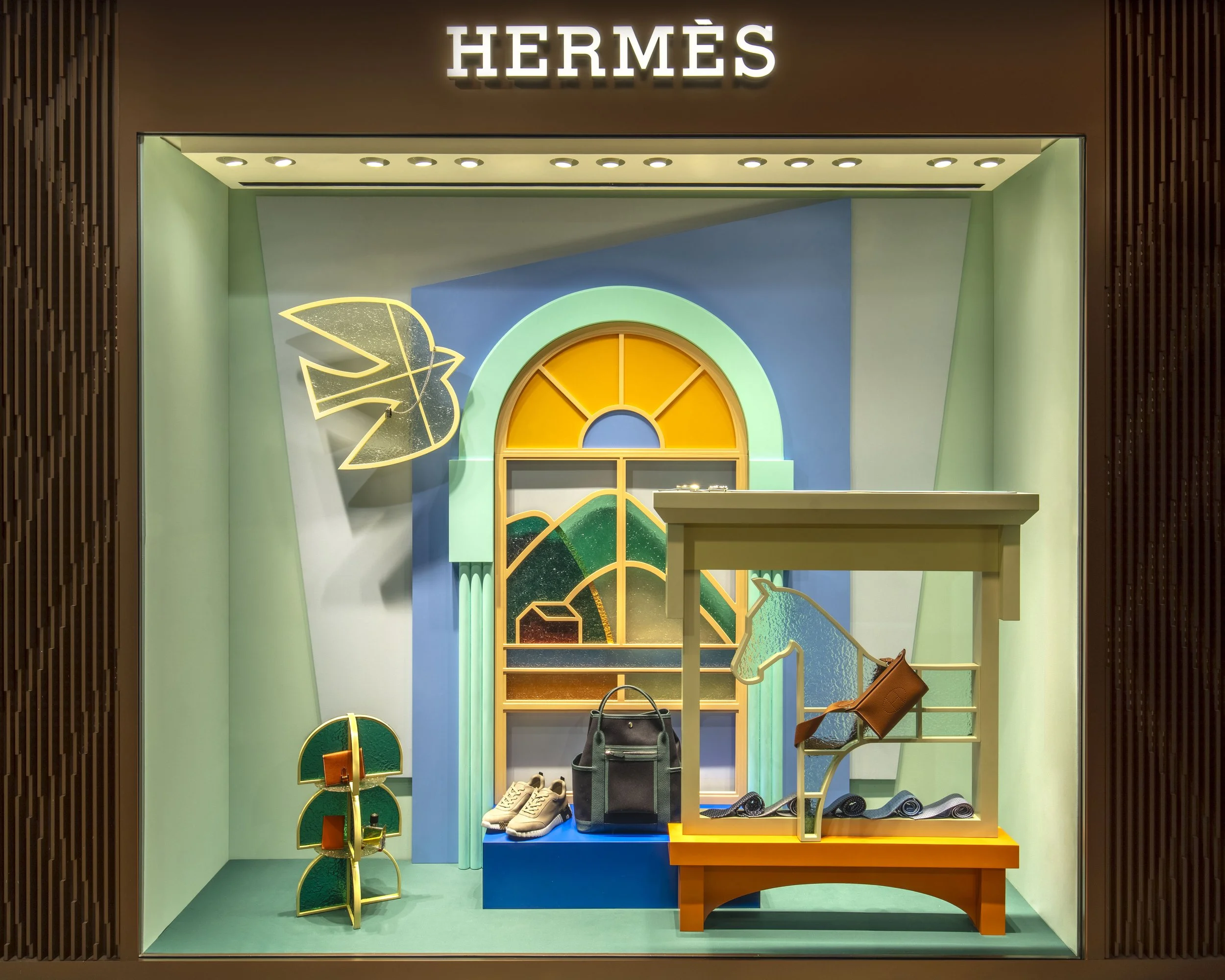 "Venture Beyond: Frames of Fantasy," a luxury Hermès window display installation by Cynthia Mak reimagining doors, windows, and gates.