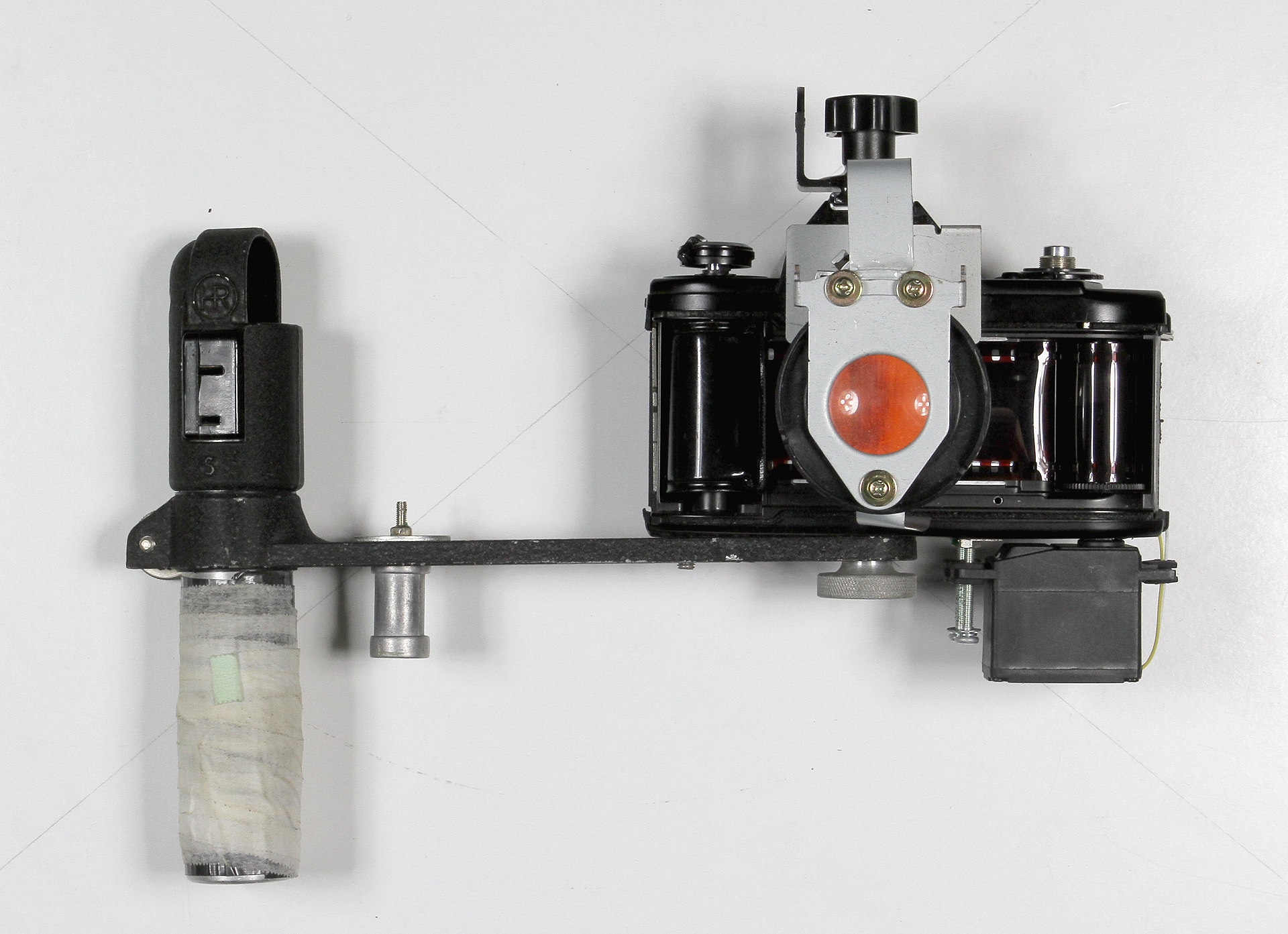   35mm Slide Film Viewer  2016.&nbsp; Nikon EM body, flash bracket, modified servo motor, SPST switch, 2xAA battery holder, white LEDs, Holga macro attachment, SLR ground glass, metal pieces from a broken printer, nuts, screws, super glue. 