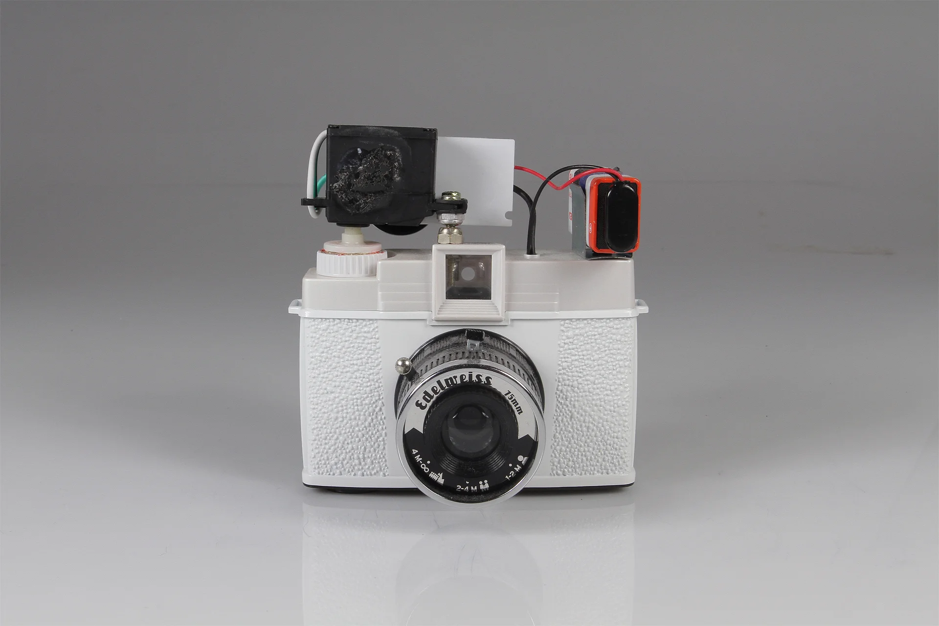 Diana Slitscan Camera 2016. Modified Diana+ with 35mm film back for Strip Photography. Diana+ camera, modified servo motor, pulse-width modulation circuit (for motor speed control), 9v battery, battery clip, electrical wire, salvaged nuts and bolts.