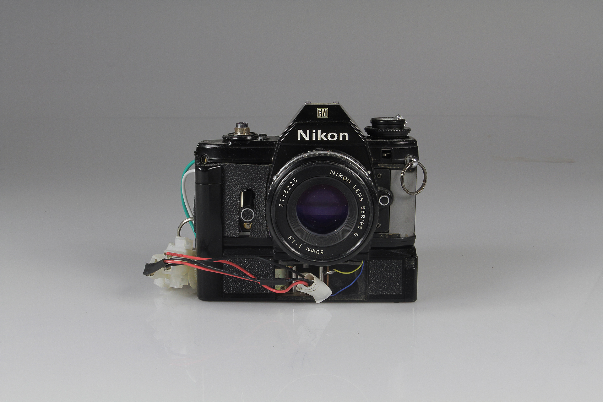   Nikon Slitscan Camera  2014.&nbsp; Modified Nikon EM SLR and Motor Drive for Strip Photography.&nbsp; Nikon EM SLR w/ motor drive, pulse-width modulation circuit (motor speed control), black-rubberized 4x5" film (to form the slit), electrical wire,