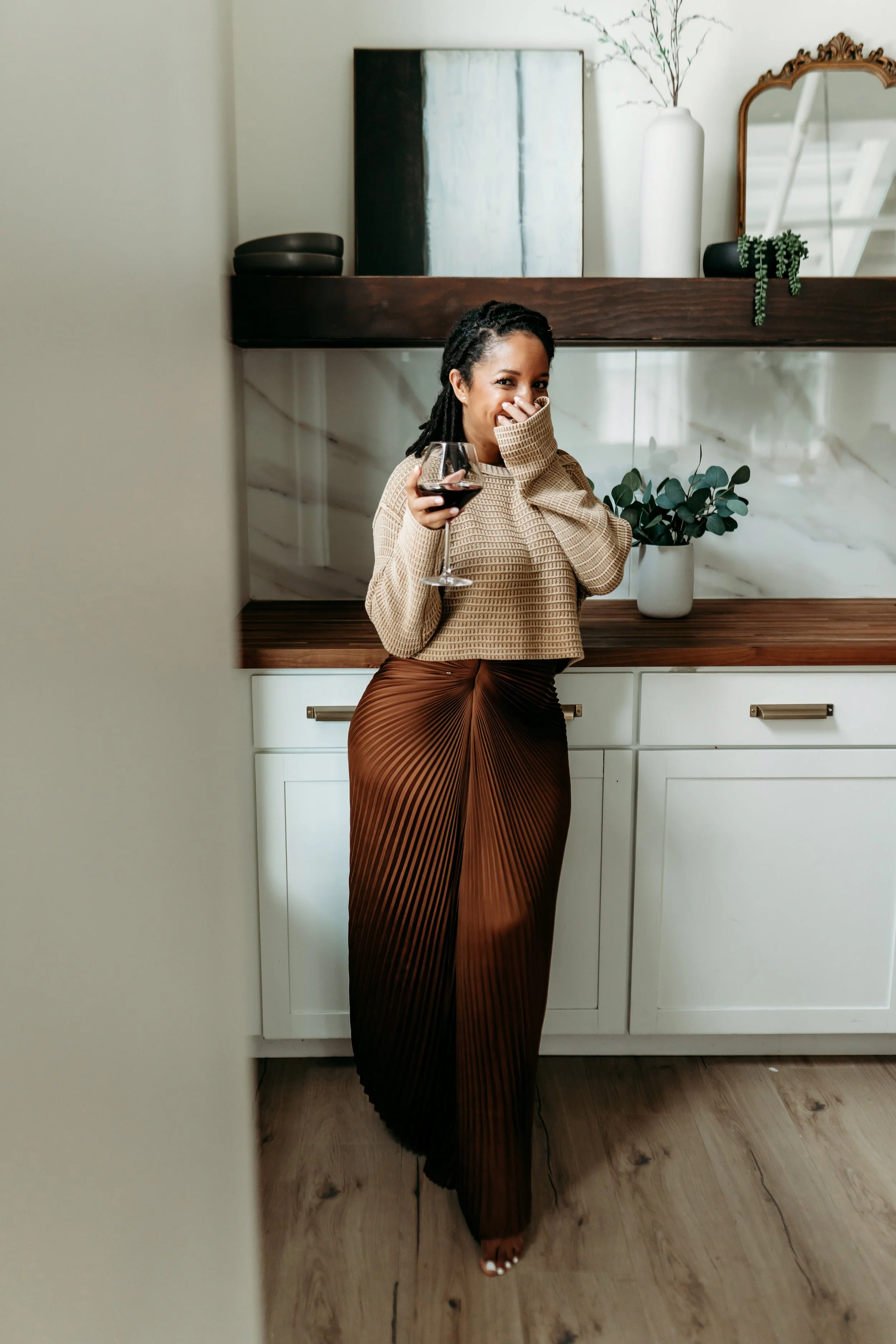 woman laughing shyly in kitchen of Alpharetta brand photo studio