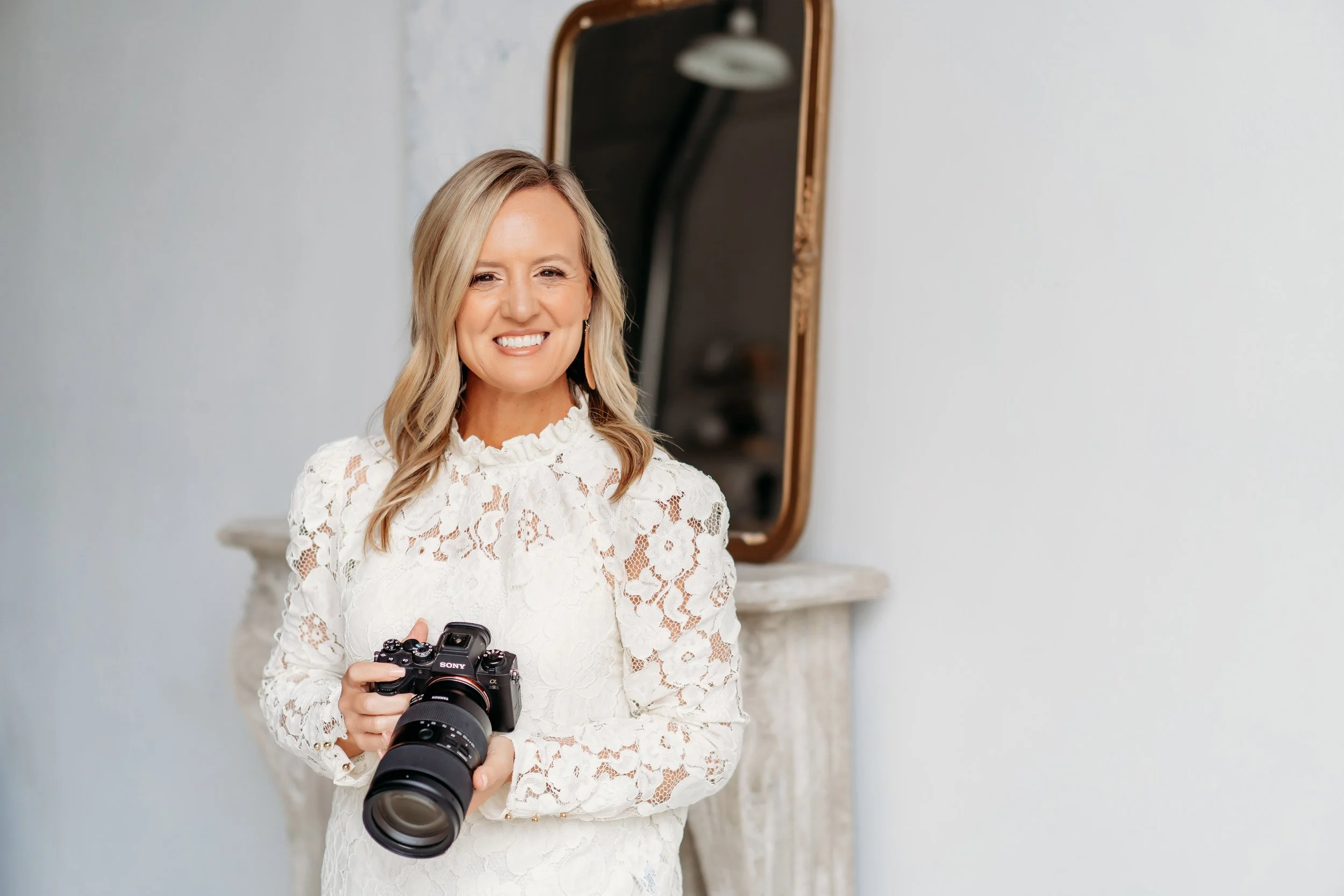 Photographer holding camera at Blanc Studio west for brand mini session