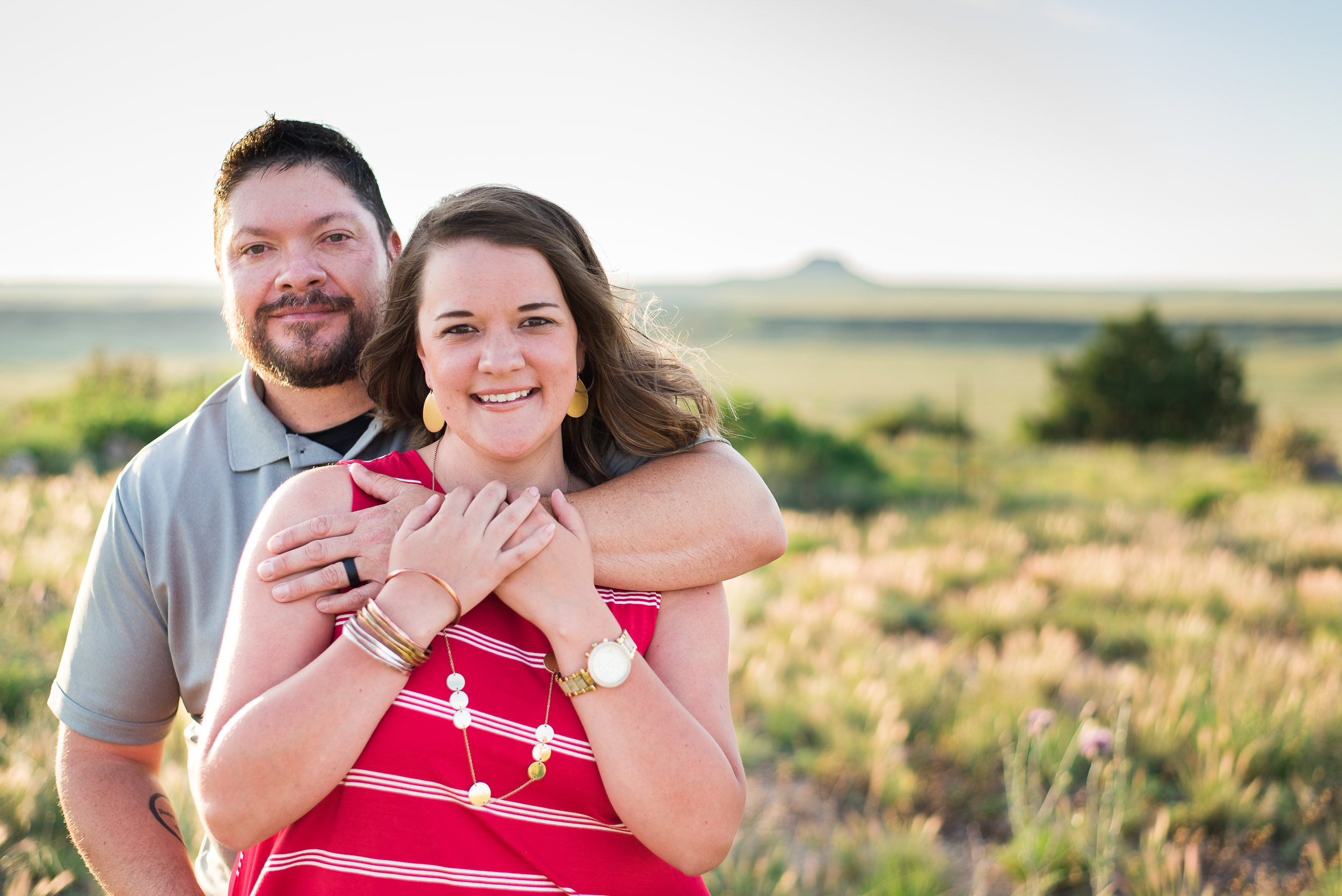 Couple in field at sunset