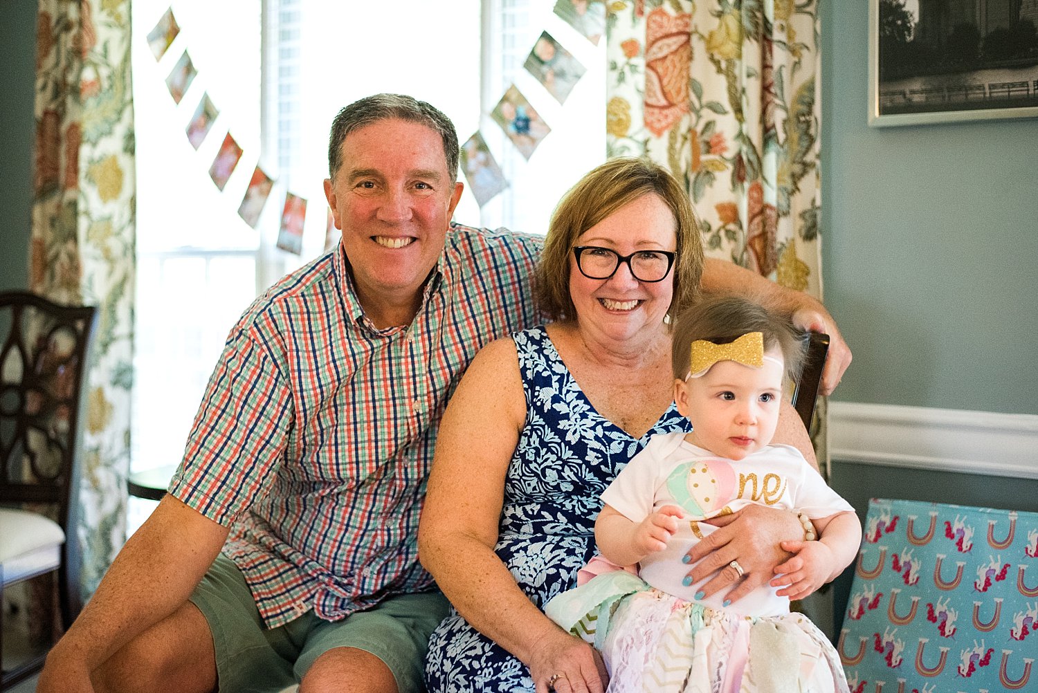 portrait of baby sitting with grandparents