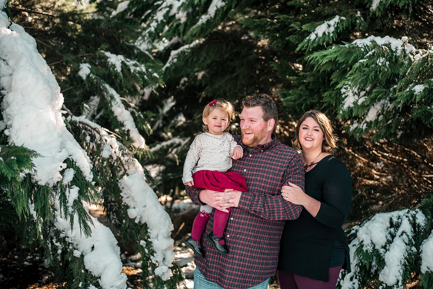 Family of 3 in snow at Barry Patch Farms, Woodstock