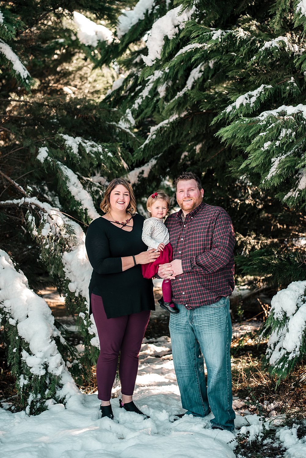 Family of 3 in snow at Barry Patch Farms, Woodstock