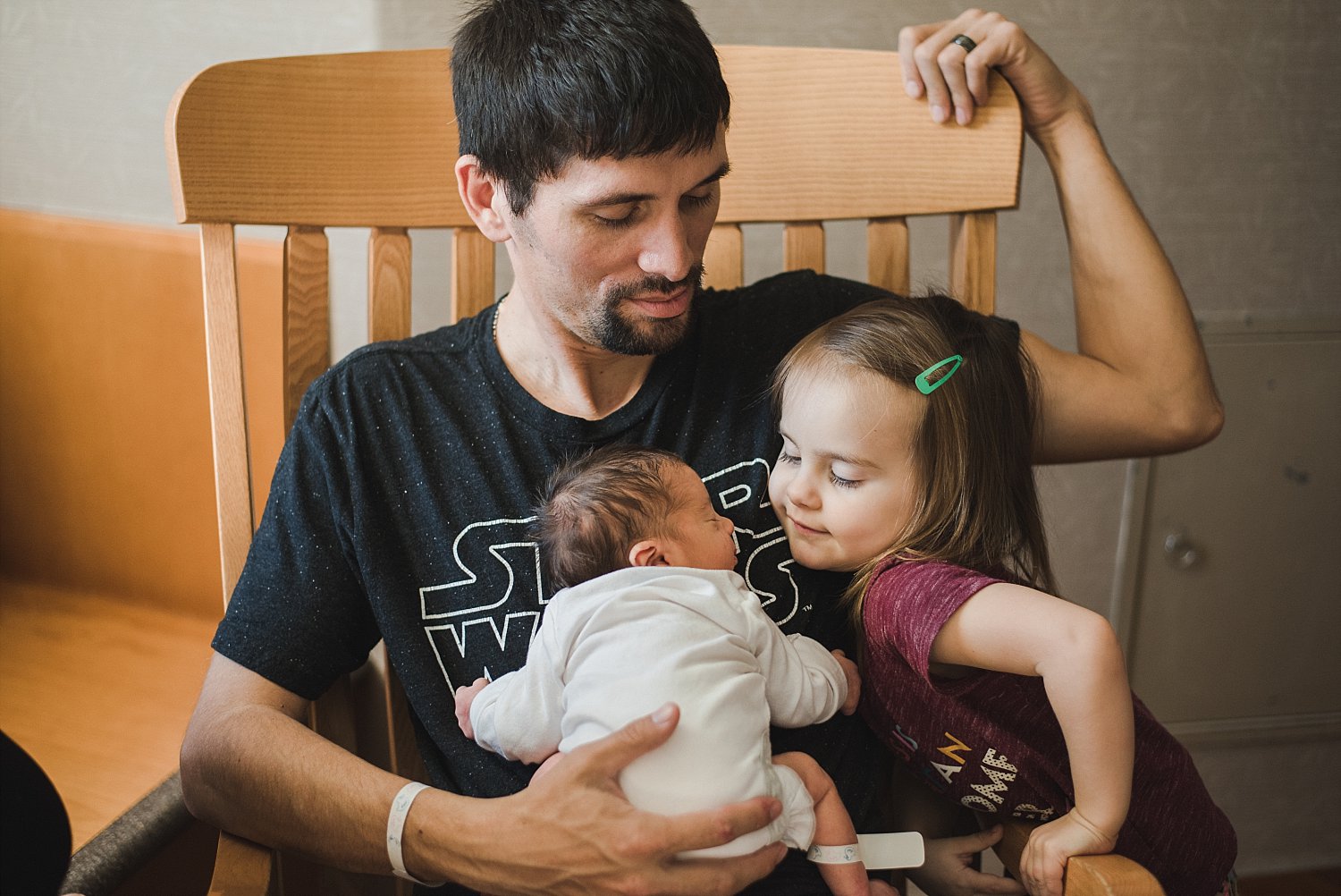 dad, baby, and toddler in rocking chair at Northside Atlanta Hospital