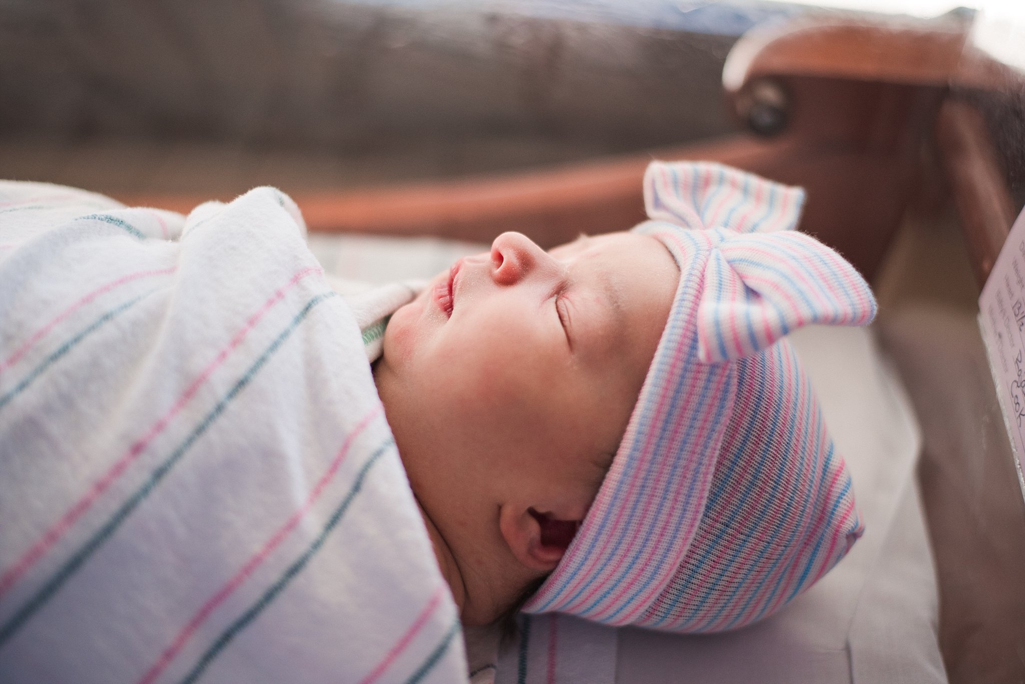 profile of baby girl sleeping in hospital bassinet | Emory Johns Creek Hospital