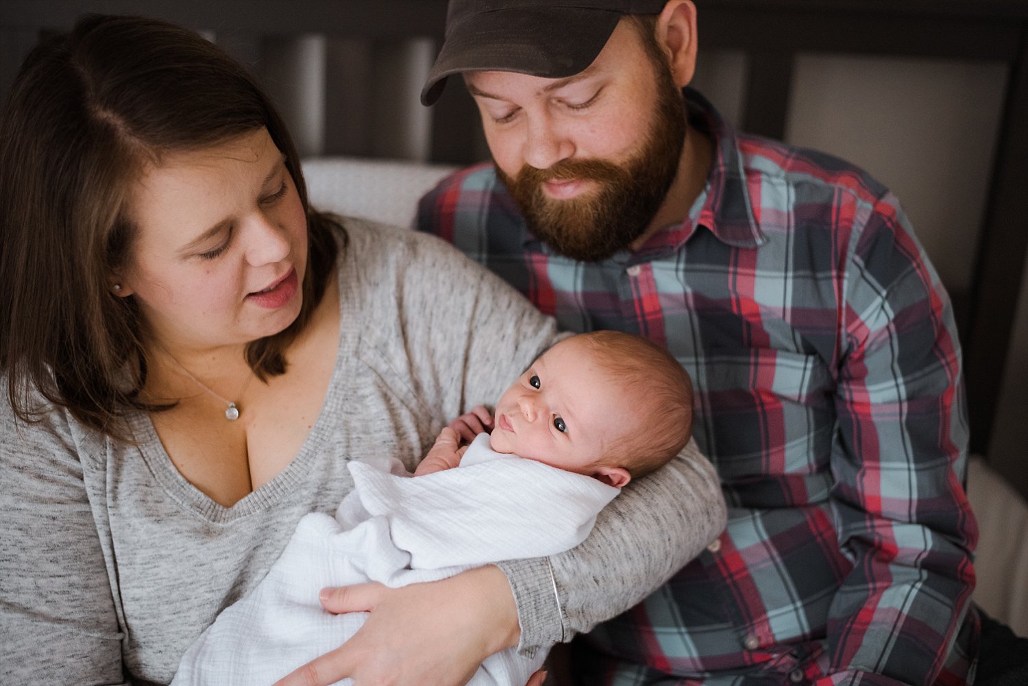 mom and dad looking at newborn baby boy
