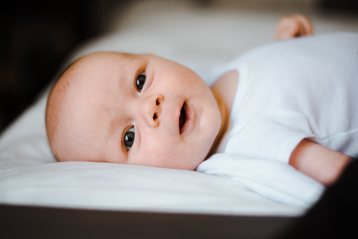 newborn baby boy smiling 