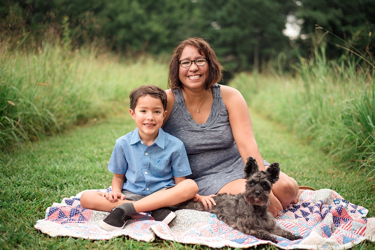 Mother son and dog on blanket at Green Meadows Preserve