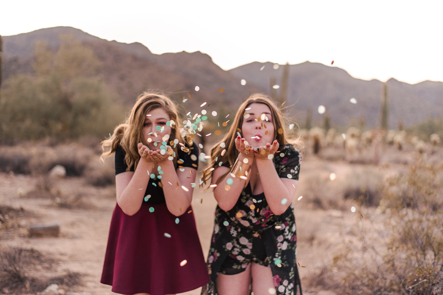 Senior girls blowing confetti