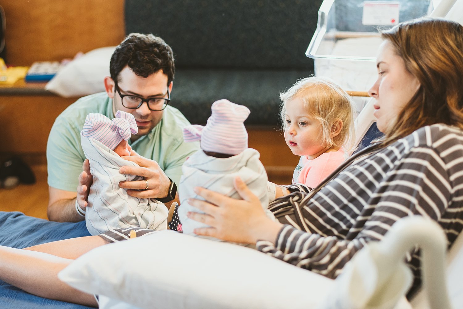 Family in hospital bed at Northside Atlanta Hospital with newborn twin girls