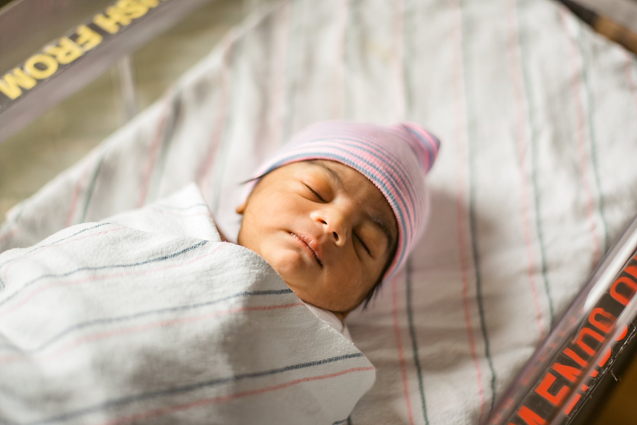 Newborn baby boy with hospital hat on