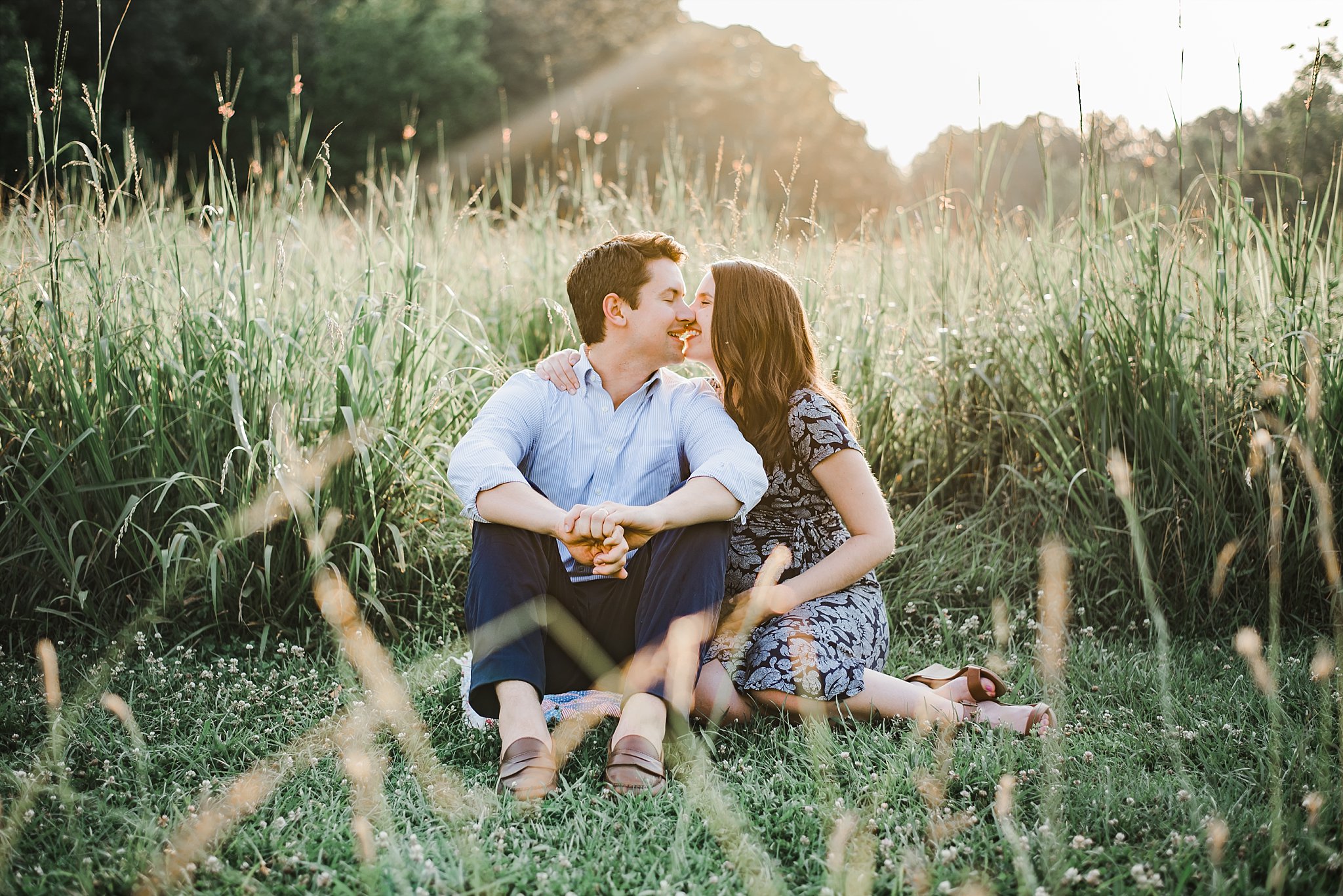 couple in field kissing Green Meadows Marietta, GA