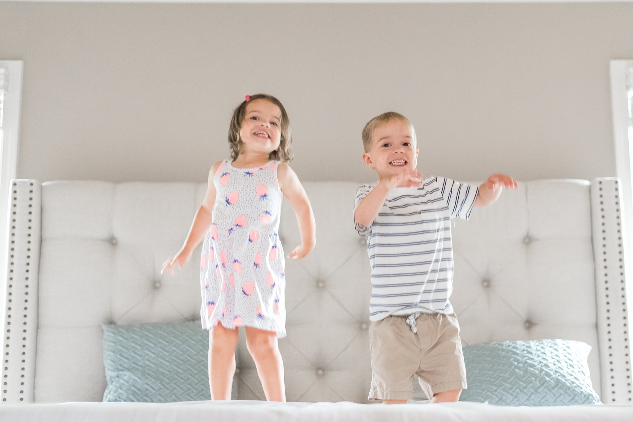 toddler twins jumping on bed