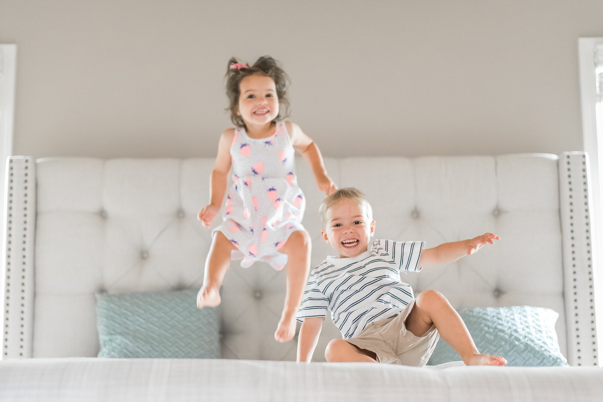 toddler twins jumping on bed