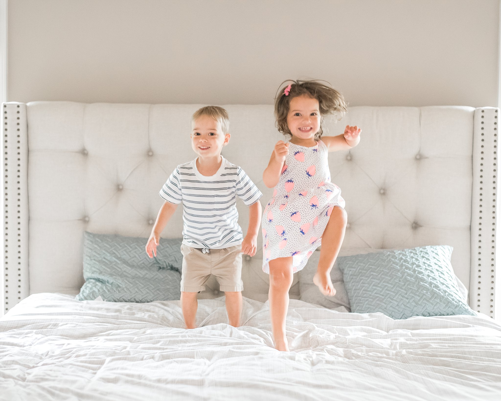 toddler twins jumping on bed