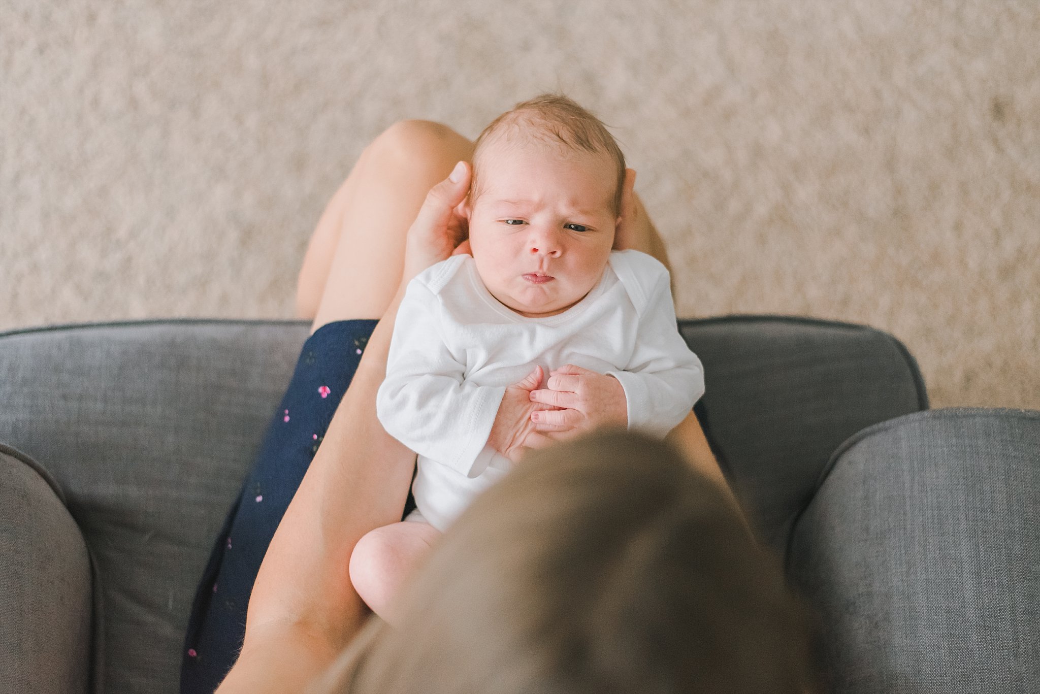 newborn boy looking up at mom