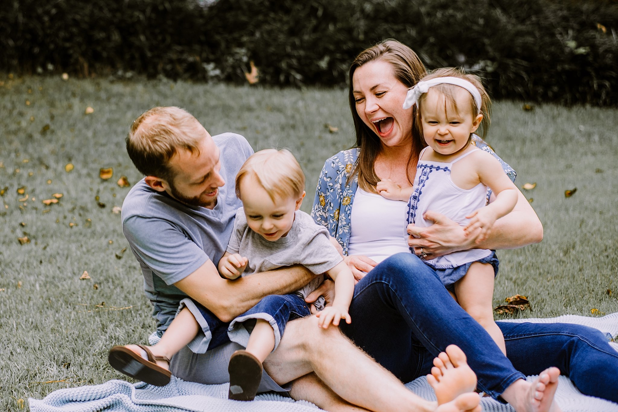 family laughing and playing in backyard
