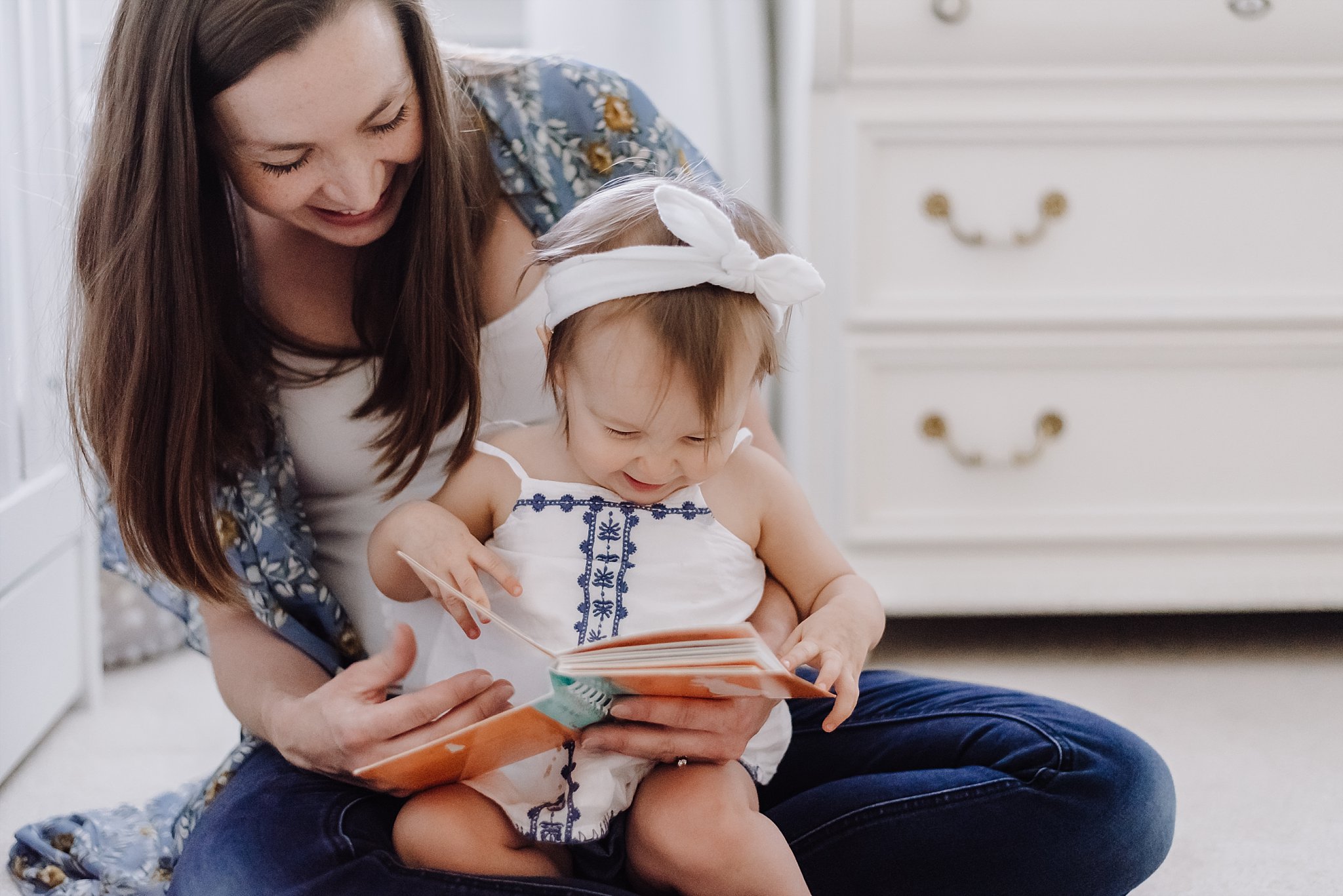 mother and daughter laughing and reading pete the bunny